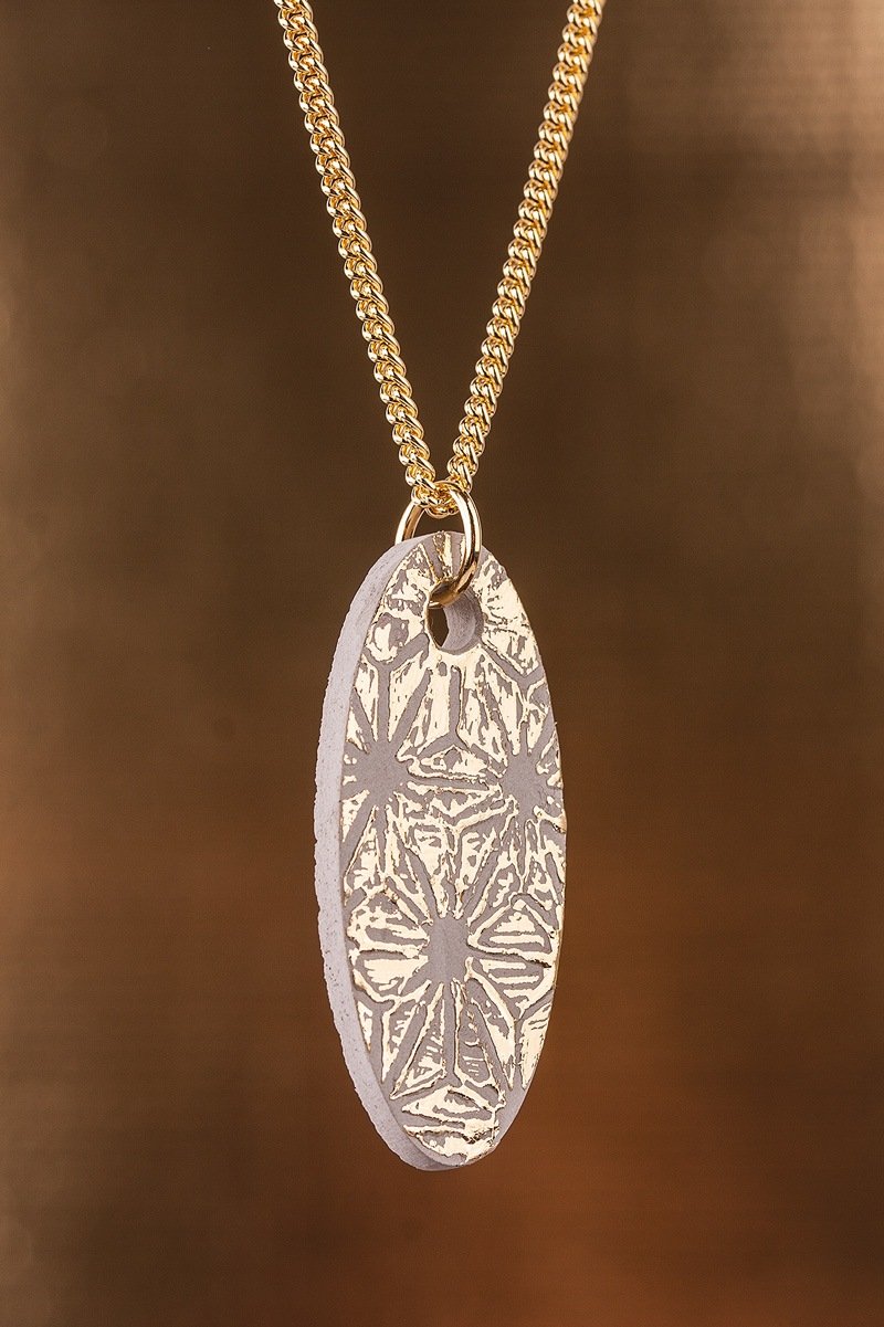 Gold-coloured  oval jewellery pendant