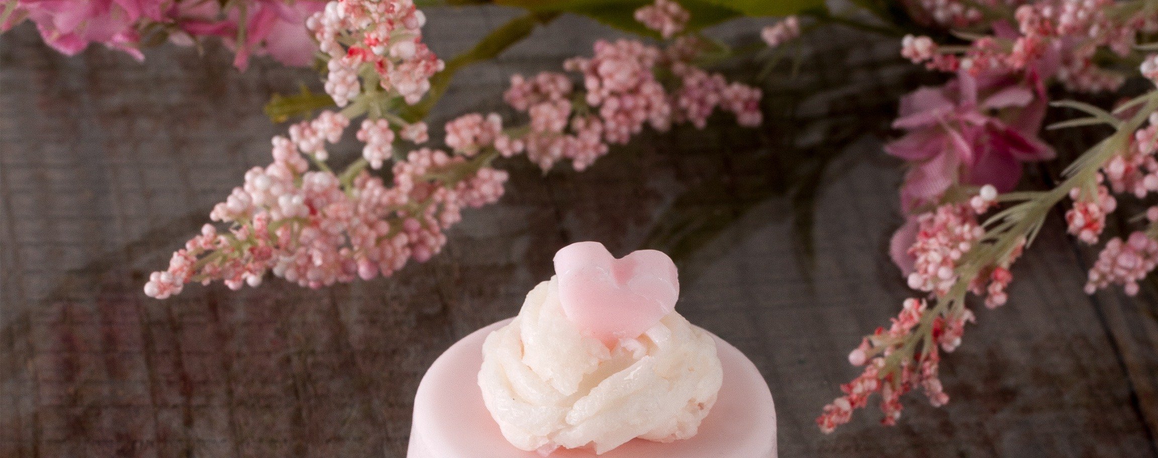 Round light-pink soap with cream rosette