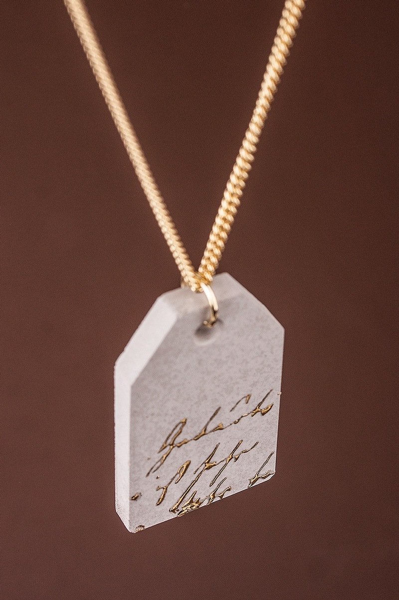 Jewellery pendant tag with gold lettering
