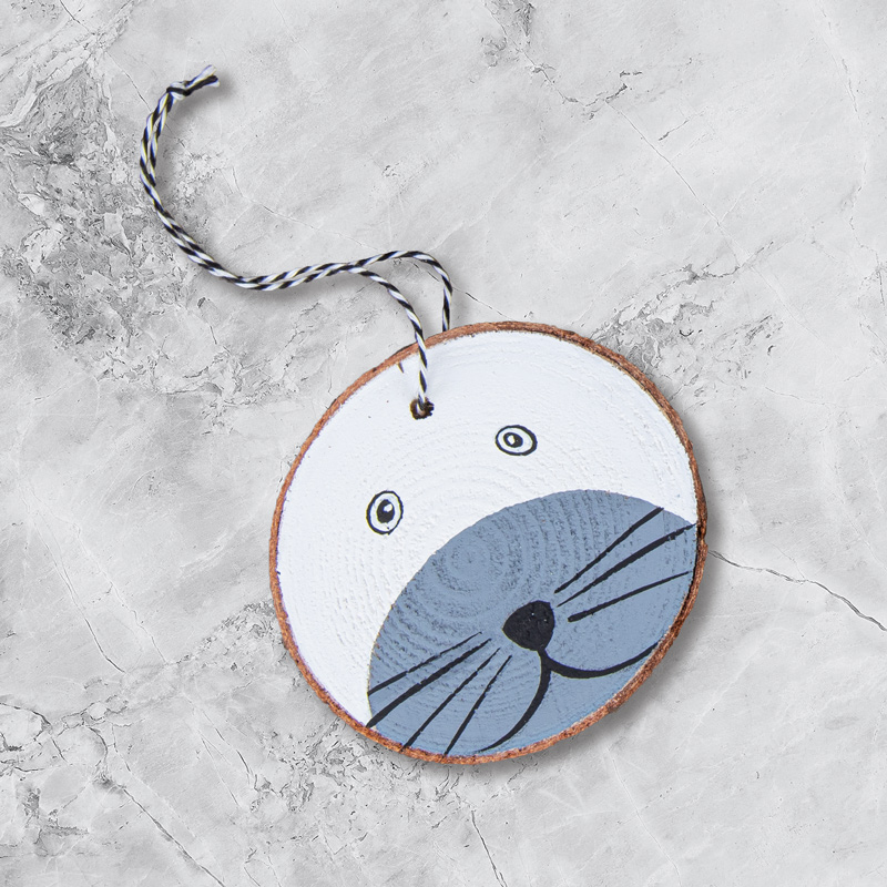 Tiergesichter auf Holzscheiben - Seehund